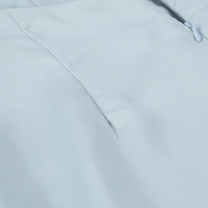 Detail of grey-blue fabric texture and high-quality invisible zipper on jumpsuit