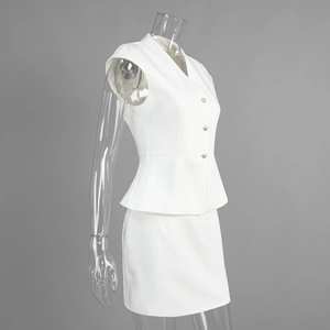 Detail of white V-neck peplum vest with metallic buttons and matching mini skirt