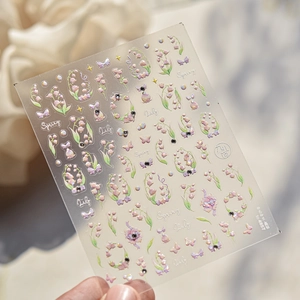 Detail of pink lily of the valley and butterfly nail stickers with holographic effects