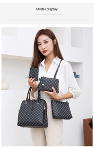 Detailed view of 4-piece dark grey printed handbag set shown on a model in a modern room