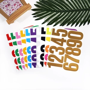 Close-up of waterproof 3-inch vinyl number stickers in various colors and metallic gold