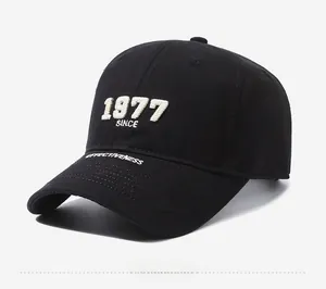 Close-up of black baseball cap featuring 1977 SINCE embroidery and cotton twill texture