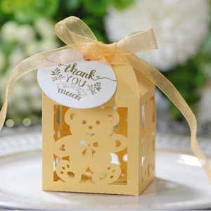 Laser cut yellow baby shower candy box with teddy bear design and gold ribbon tie