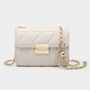Detailed view of cream white quilted handbag with gold square clasp and chain strap