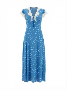 Detail of V-neckline with delicate white lace trim on a blue polka dot maxi dress