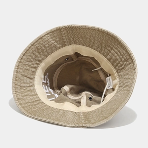 Inside view of washed cotton bucket hat showing stitching, lining and metal eyelets