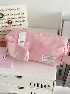 Detail of light pink large capacity pencil case with side pocket and buckle closure