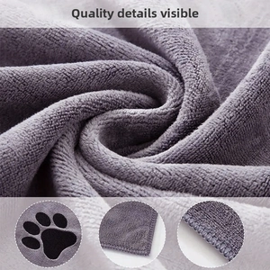 Macro detail of purple microfiber pet towel showing thickness and cute paw print pattern