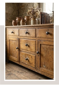 Macro detail of antique metal handles on a vintage wooden sideboard cabinet with rustic texture