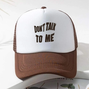 Brown and white mesh trucker hat with 'DON'T TALK TO ME' text on minimalist white table