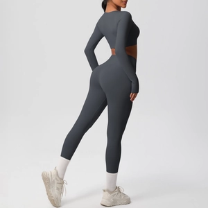 Detail view showing high-waisted gray leggings and long-sleeve crop top yoga set