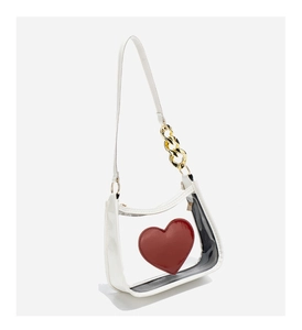 Detail of white leather and clear PVC crossbody bag with red heart and gold chain