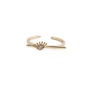 Detailed close-up of gold evil eye ring with clear zircon stone and eyelash design