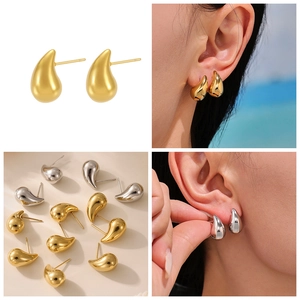Detailed view of polished water drop earrings in gold and silver finishes on a model
