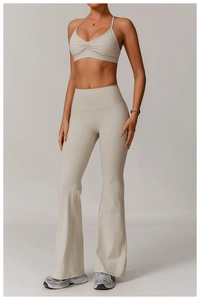 Detail of V-neck yoga bra with cross back and ruched front in soft cream color fabric