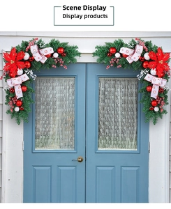 Detail showing a pair of Christmas swags with red poinsettias and festive ornaments