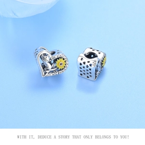 Detail of S925 sterling silver charms featuring yellow sunflower and cat engraved designs