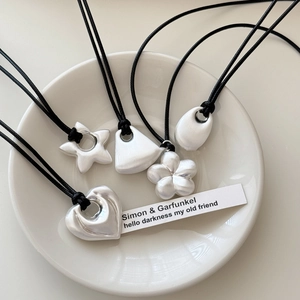 Minimalist matte silver pendant set with heart star shapes and black cord necklaces