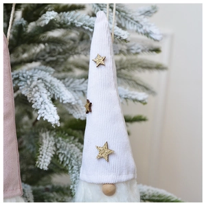 Close-up of white plush Christmas gnome ornament with corduroy hat and golden star detail