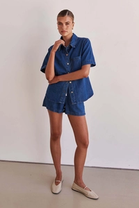 Detail view of washed navy blue denim set with short sleeve button-up shirt and shorts