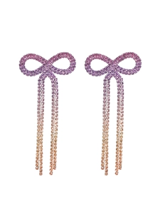 Detail of bowknot tassel earrings with purple and orange gradient rhinestones
