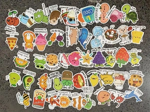 Flat lay of colorful cartoon pun stickers with motivational text on textured background