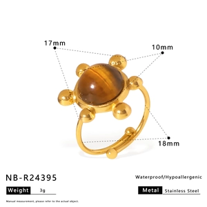 Detail view of adjustable gold stainless steel ring featuring a round tiger eye stone