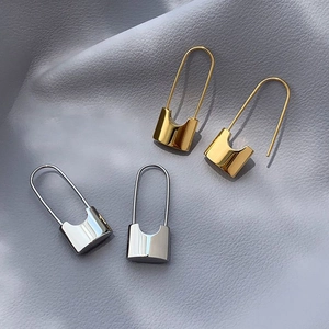 Minimalist padlock shaped hoop earrings in polished gold and silver metal finishes