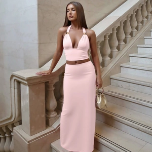 Detail of pink two-piece set featuring a halter crop top and slim fit high waist maxi skirt