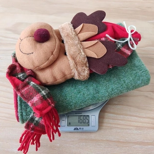 Detail view of 3D reindeer chair cover with red plaid scarf on scale weighing 168.5g