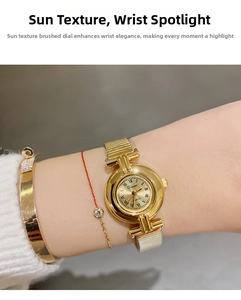 Close-up of an elegant gold-tone women's quartz watch featuring a sunray dial and Roman numerals.