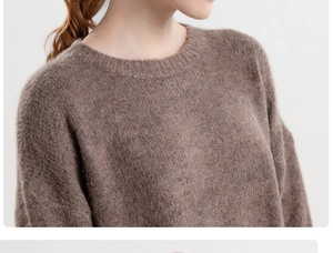 Detailed view of the brown knit beanie showing soft textured fabric and round opening