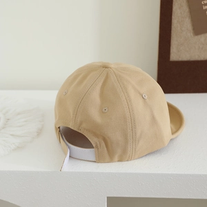Detail view of khaki baby baseball cap featuring adjustable velcro strap and soft twill fabric
