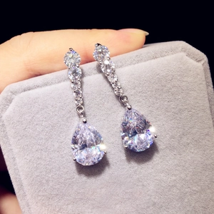Exquisite silver drop earrings with sparkling pear-cut zircon held in a jewelry box