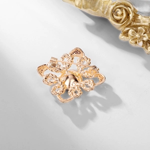 Vintage gold textured glass crystal brooch with intricate woven metal and safety pin clasp