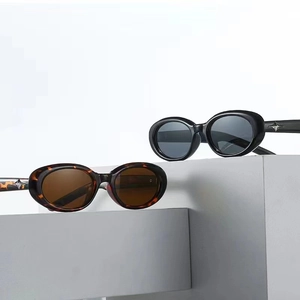 Detail view of oval sunglasses featuring silver star metal accents on the temple arms