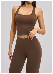Detail of dark brown racerback sports bra and high-waisted leggings yoga set texture