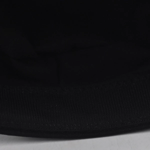 Macro shot of durable black twill fabric texture and neat edge stitching on military cap