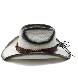 Detail of white straw cowboy hat featuring ombre edges and golden steer skull metal accent