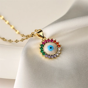 Detailed macro view of evil eye sunflower pendant with multi-color zircons on white silk