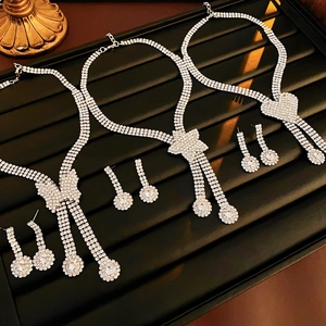 Silver rhinestone heart star necklace and earrings jewelry set displayed on velvet
