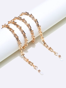 Close-up of gold U-link chain with rubber loops and lobster clasp for eyewear