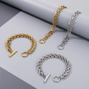 Detail of mixed-metal Cuban and paperclip bracelets with T-bar toggles and O-ring clasps