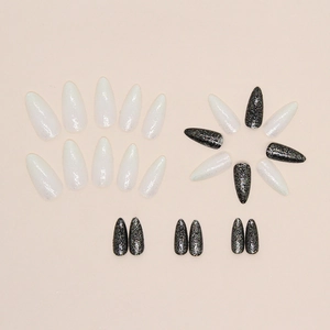Sparkly almond press-on nails in black and white colors with fine glitter finish