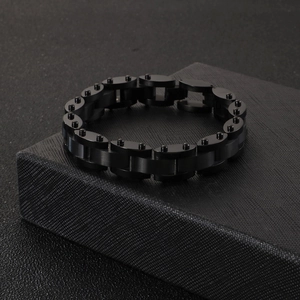 Macro shot of matte and polished black titanium chain bracelet on textured jewelry box