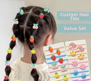 Detailed close-up of colorful cartoon elastic hair ties with fruit and flower soft rubber charms