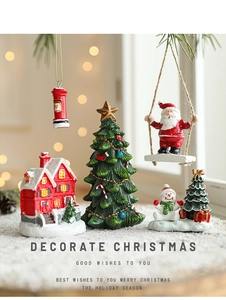 Miniature resin Christmas village set with Santa, snowy house and tree on faux snow