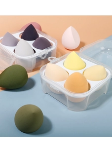 Detail of colorful makeup sponges in transparent boxes on dual tone background