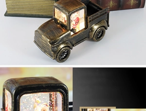 Macro shot of bronze vintage Christmas truck lantern with glowing LED light and snow