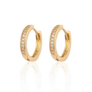 Elegant gold round hoop earrings with sparkling white zircons on a white reflective base